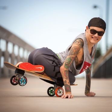 MC Wheels showing off his skateboard skills.