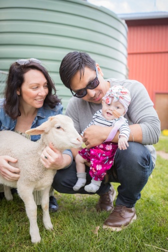 Willow and her parents with a lamb