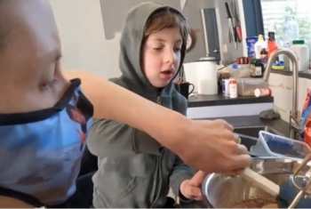 NDIS participant Bree-Arne Manley cooking with son Jayden
