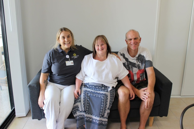 Heath and Emma sit with support worker Jessica (on the left)