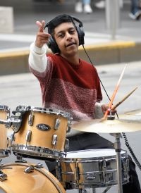 Eshan Lakhani pointing to the camera while performing