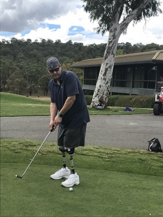 Nathan plays around of golf with the aid of his prosthetic legs