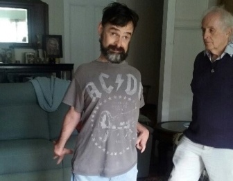Adam standing next to his father Brian, looking at camera
