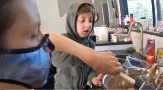 NDIS participant Bree-Arne Manley cooking with son Jayden