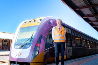 Henry John standing in front of a V/Line train 