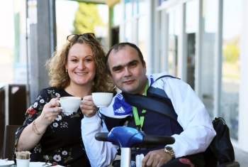 Julie and Tony enjoy a coffee together at a cafe