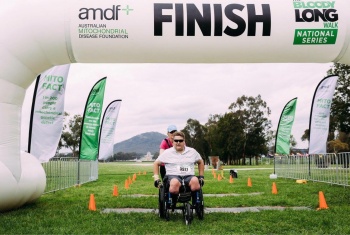 Nathan crosses the finish line of a marathon he using his race wheelchair