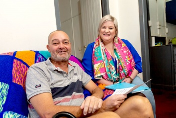 Bill Nolles sits in his home with a support worker