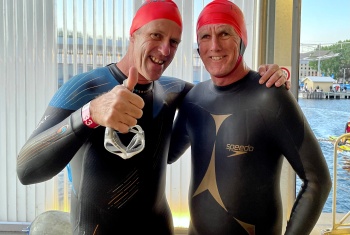 Jason Clark and John Domandl in their wetsuits with Jason giving a thumbs up.