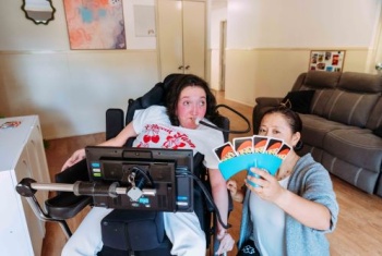 Jessika playing a card game in her home